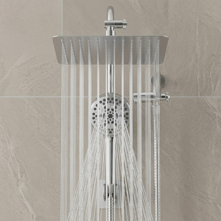Chrome shower head and control panel on a tiled wall